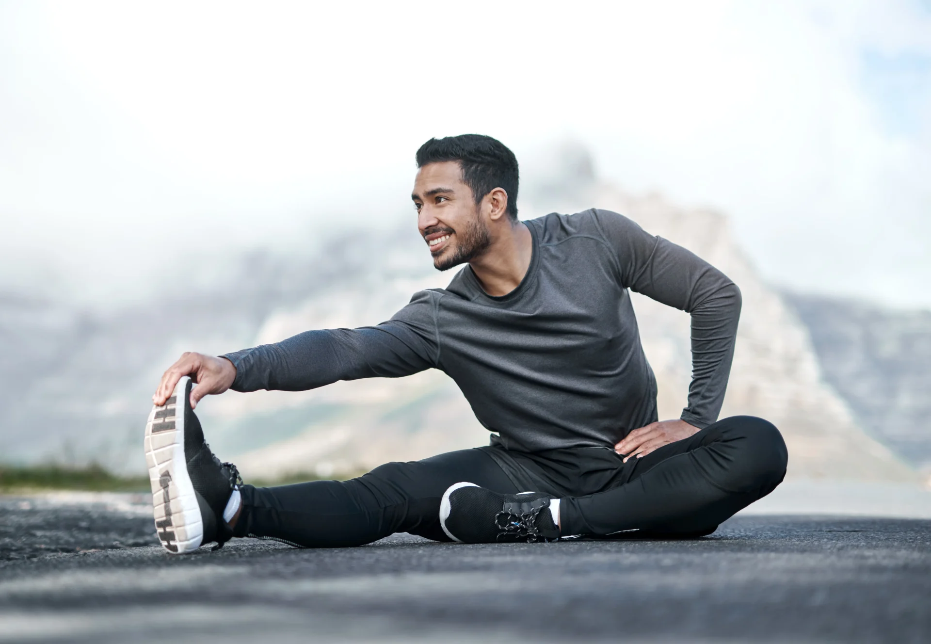 Man stretching outdoors before workout.