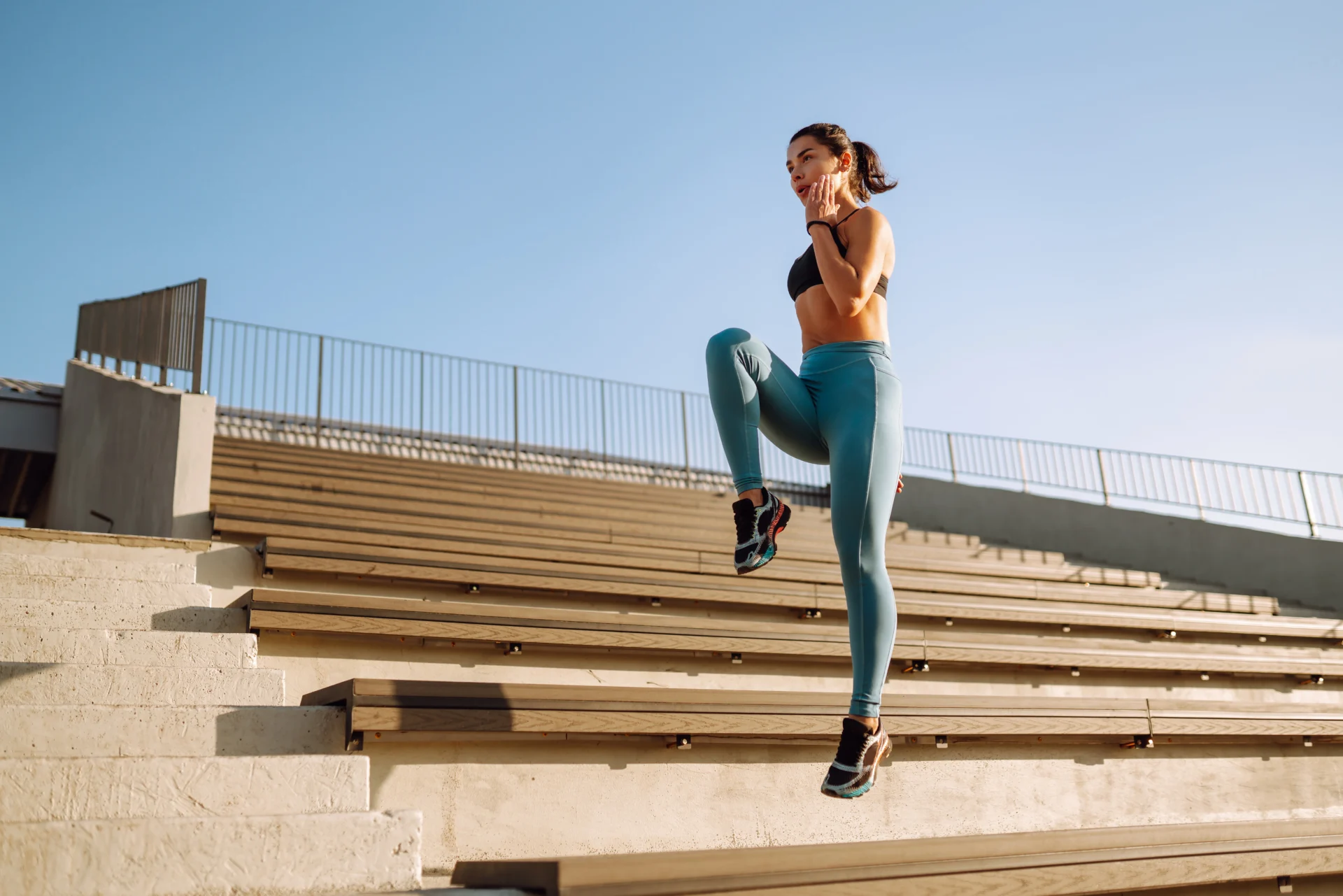 Woman exercising, stair workout, sunny day.