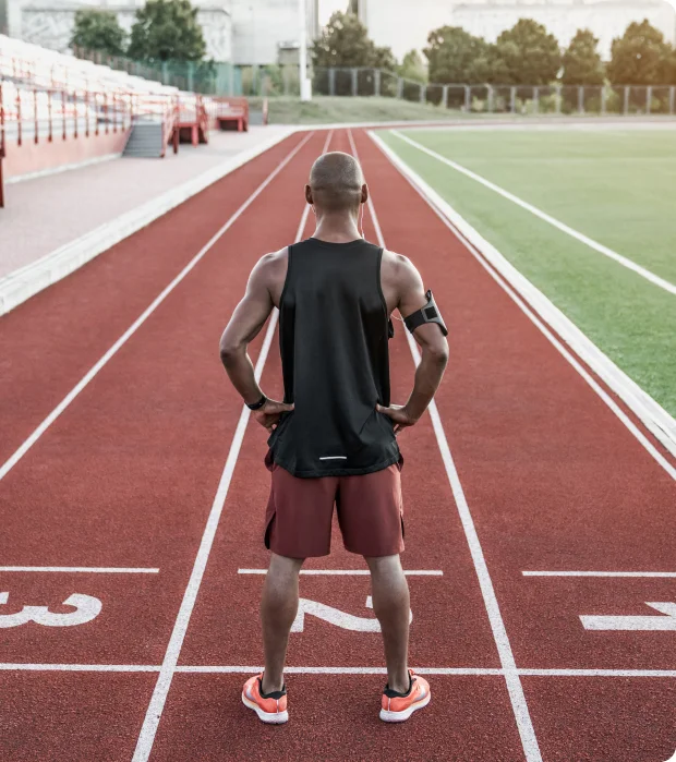 Athlete standing on running track.